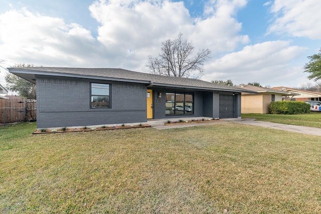 ranch-style house featuring a garage and a front lawn