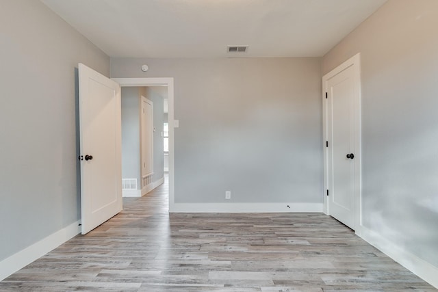 unfurnished room with light wood-type flooring