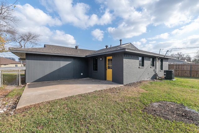 back of house with a patio, a lawn, and central air condition unit