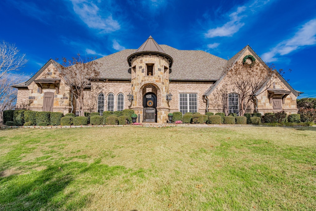 french provincial home featuring a front lawn