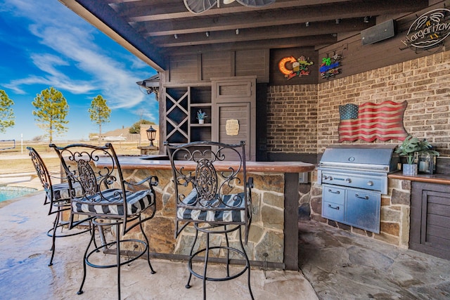 view of patio / terrace with area for grilling, grilling area, and exterior bar