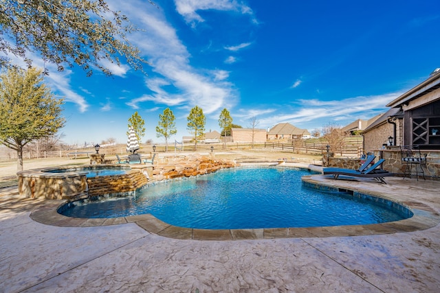 view of swimming pool with an in ground hot tub, pool water feature, and a patio