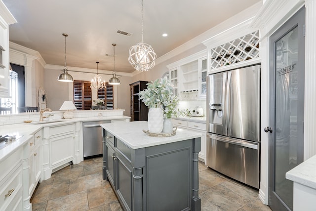 kitchen featuring white cabinetry, tasteful backsplash, decorative light fixtures, gray cabinets, and stainless steel appliances