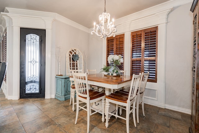 dining room featuring ornamental molding and a notable chandelier