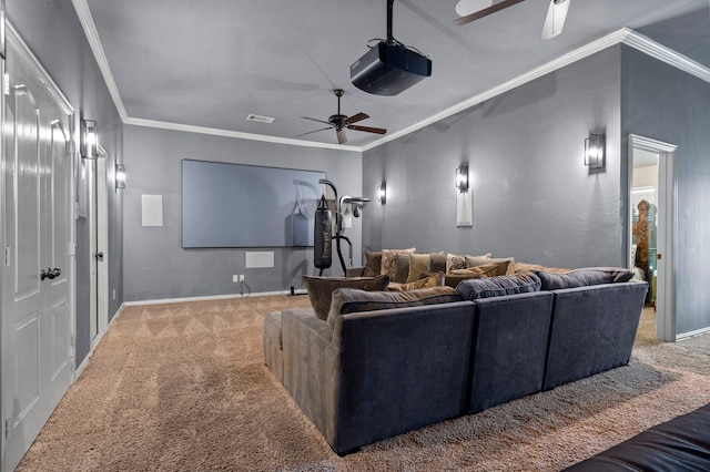 carpeted home theater room featuring crown molding and ceiling fan