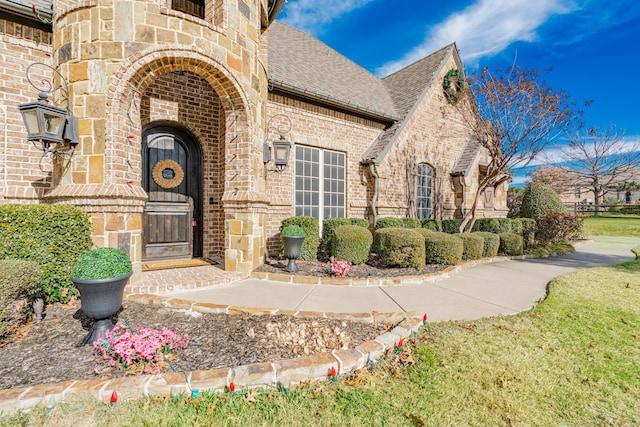 doorway to property with a lawn