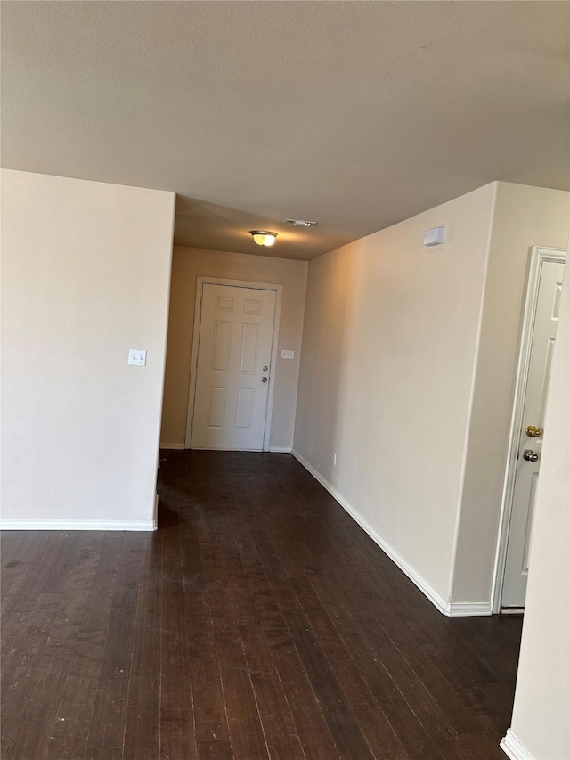 unfurnished room featuring dark hardwood / wood-style floors