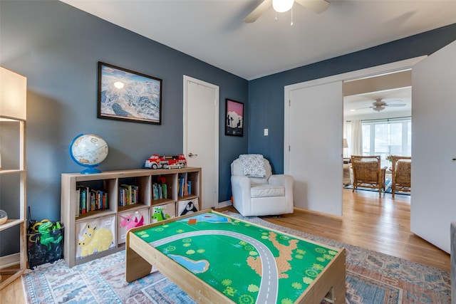 recreation room featuring ceiling fan and wood-type flooring