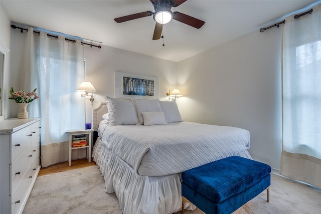 bedroom with ceiling fan and light hardwood / wood-style flooring