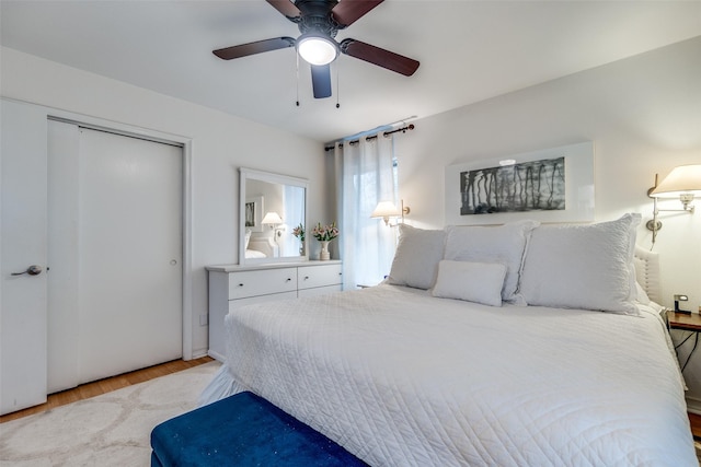 bedroom with ceiling fan, a closet, and light wood-type flooring