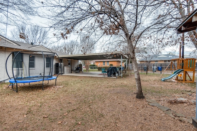 view of yard with a playground, a patio, and a trampoline