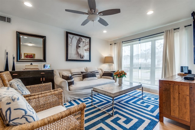 living room featuring ceiling fan and light wood-type flooring