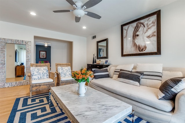 living room with hardwood / wood-style flooring and ceiling fan