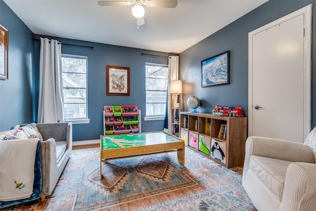 rec room with ceiling fan, wood-type flooring, and plenty of natural light