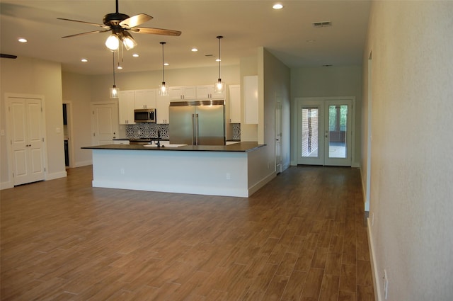 kitchen featuring ceiling fan, pendant lighting, sink, stainless steel appliances, and white cabinets