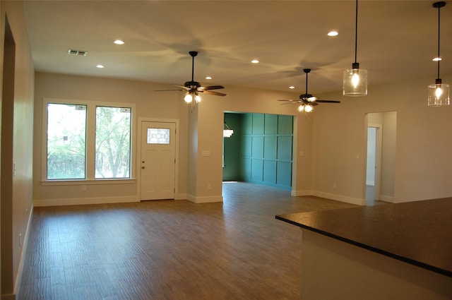 unfurnished living room featuring ceiling fan and wood-type flooring