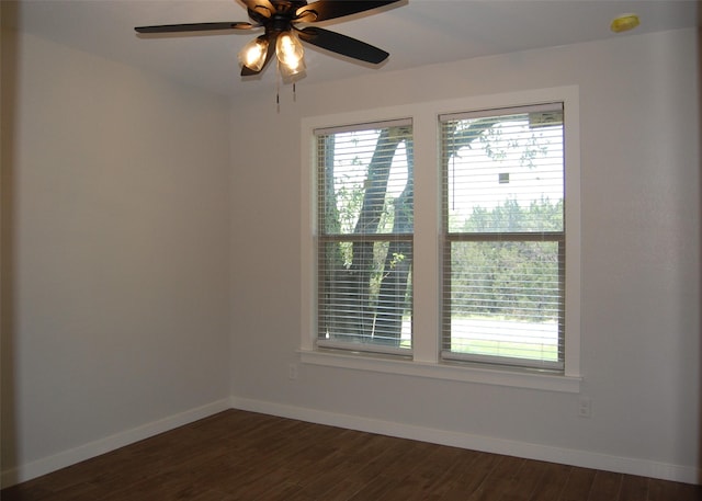 unfurnished room featuring dark wood-type flooring and ceiling fan