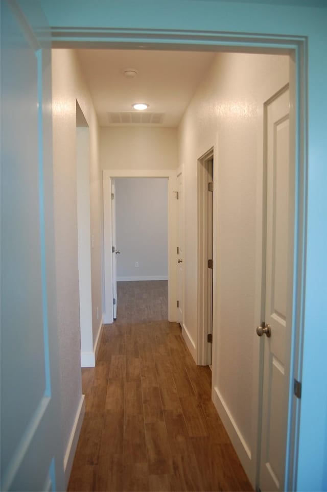 corridor featuring dark wood-type flooring