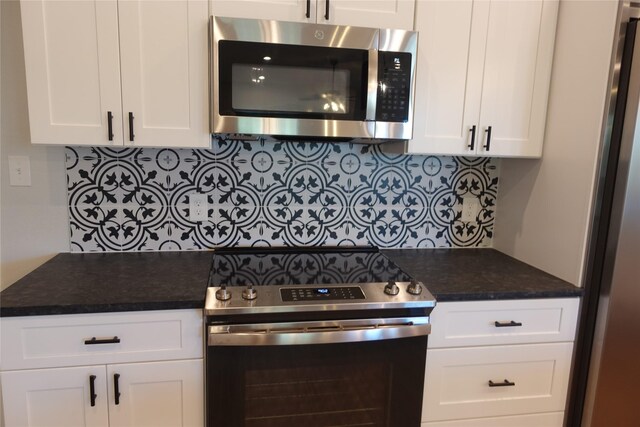 kitchen featuring white cabinetry, backsplash, and appliances with stainless steel finishes