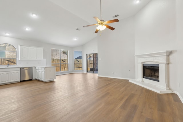 unfurnished living room featuring ceiling fan, high vaulted ceiling, and light hardwood / wood-style floors