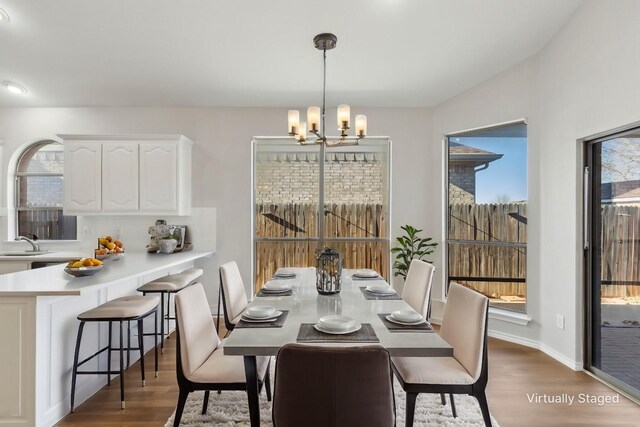 unfurnished dining area featuring sink, a wealth of natural light, and light hardwood / wood-style floors