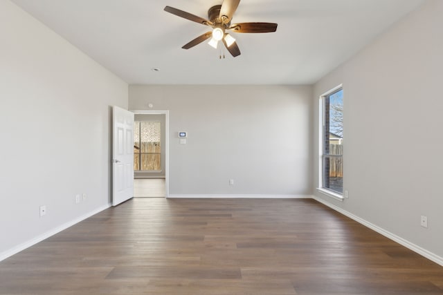 spare room featuring dark hardwood / wood-style floors and ceiling fan