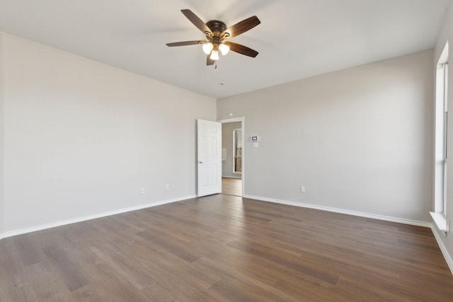 empty room featuring ceiling fan and dark hardwood / wood-style flooring