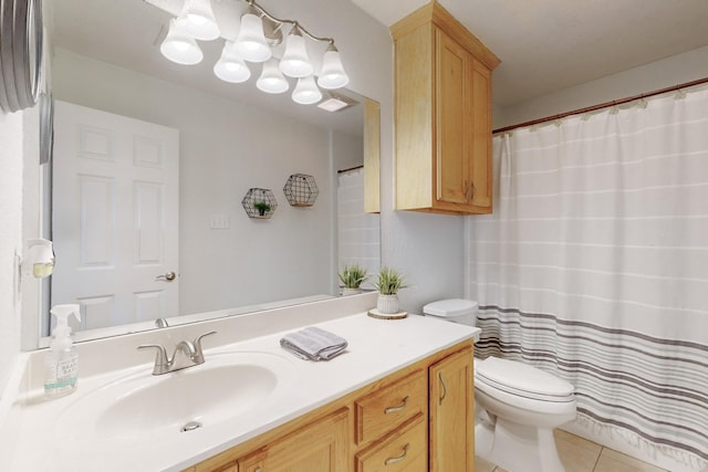 bathroom featuring vanity, toilet, and tile patterned flooring