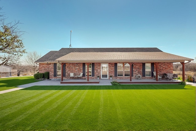 back of property featuring a yard and a patio