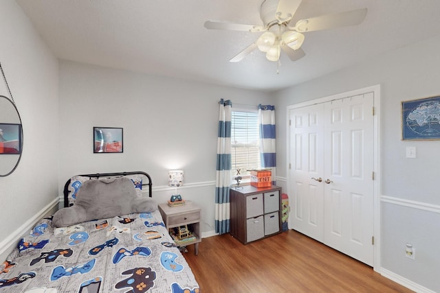 bedroom featuring hardwood / wood-style floors, a closet, and ceiling fan