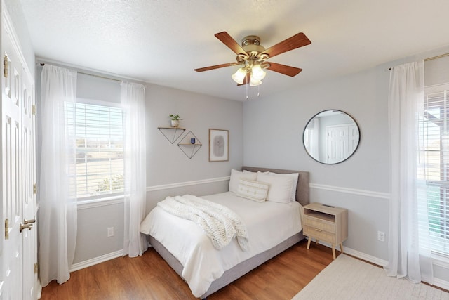 bedroom with ceiling fan and wood-type flooring