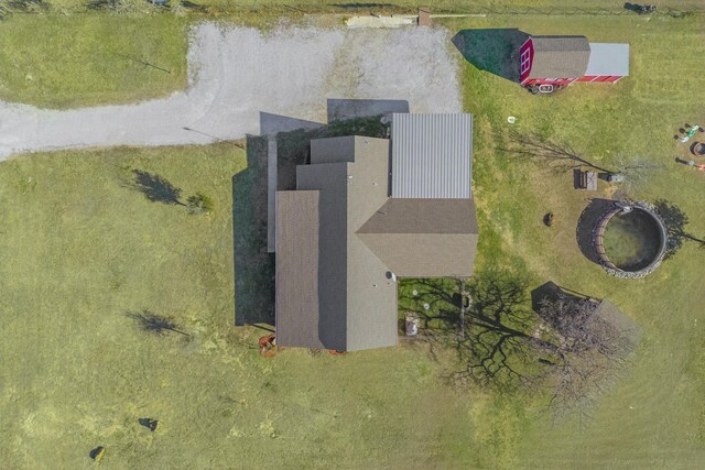 view of outdoor structure featuring a rural view and a yard