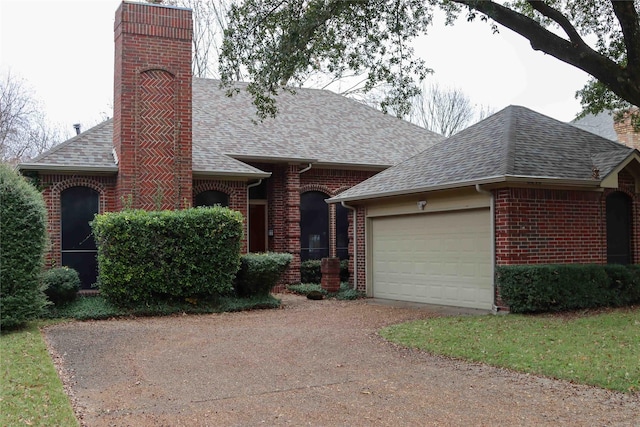 ranch-style home featuring a front yard and a garage