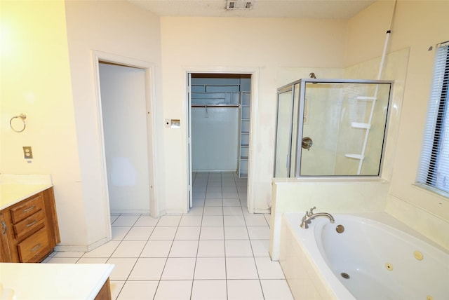 bathroom featuring vanity, tile patterned flooring, a textured ceiling, and plus walk in shower