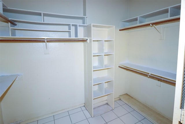 walk in closet with light tile patterned floors