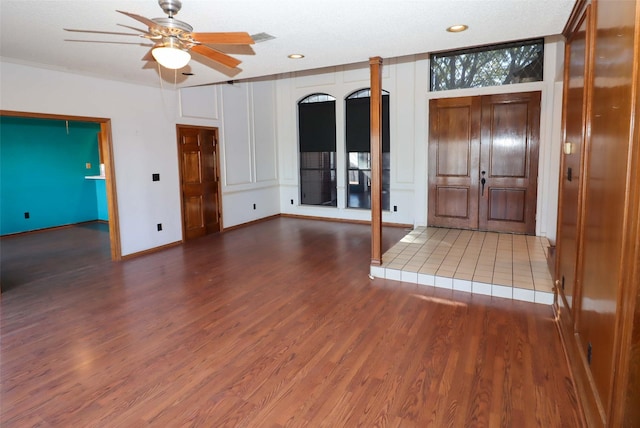 foyer entrance with hardwood / wood-style flooring, a textured ceiling, and ceiling fan