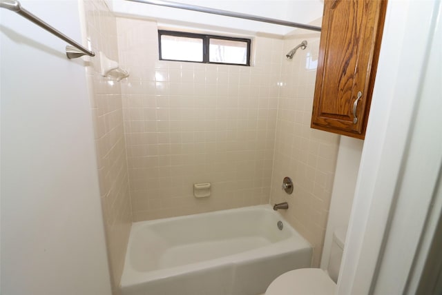 bathroom with toilet and tiled shower / bath combo