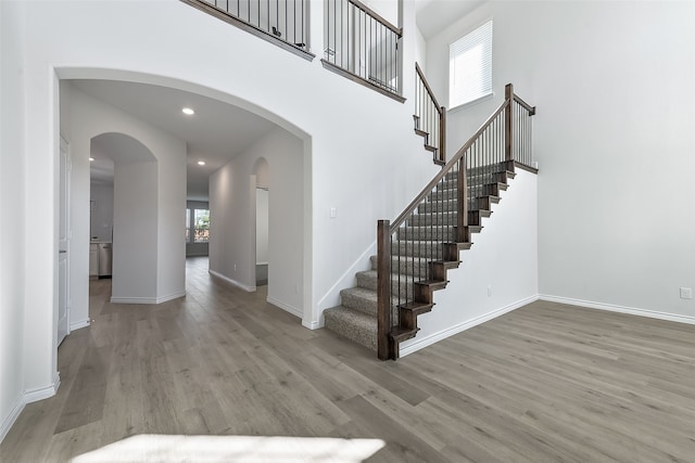 staircase with hardwood / wood-style flooring