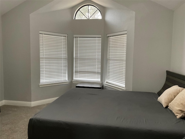 bedroom featuring light carpet and lofted ceiling