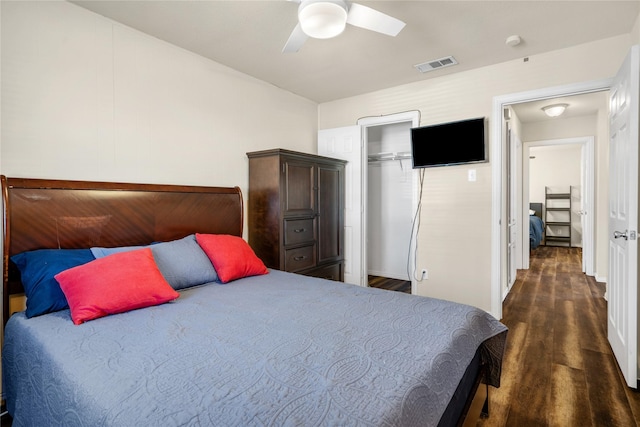 bedroom with ceiling fan, dark hardwood / wood-style flooring, and a closet