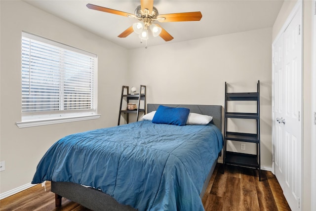 bedroom with ceiling fan and dark wood-type flooring