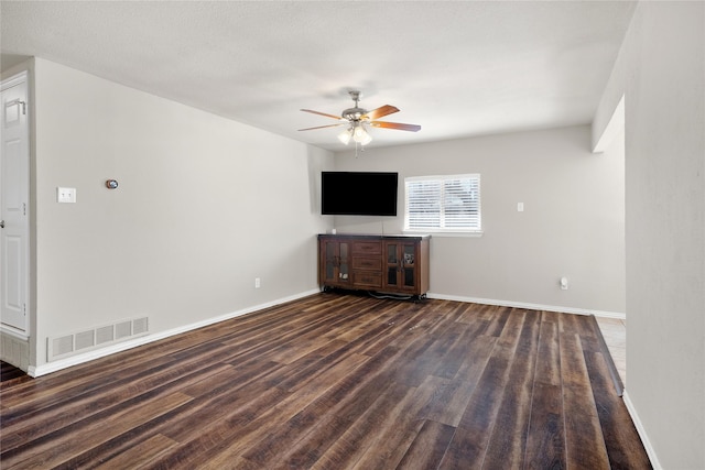 unfurnished living room featuring ceiling fan and dark hardwood / wood-style floors