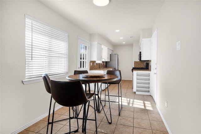 dining room featuring sink and light tile patterned floors