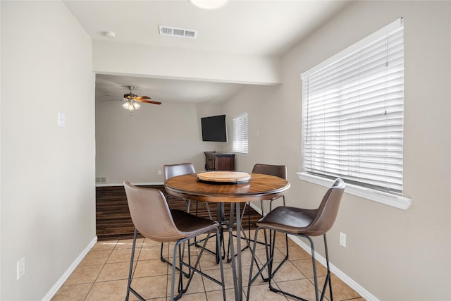 tiled dining room featuring ceiling fan