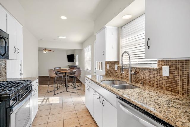 kitchen with sink, white cabinets, and stainless steel appliances