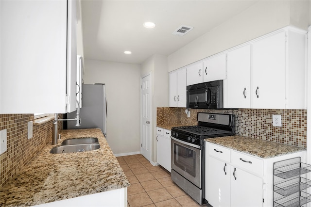 kitchen with white cabinetry, decorative backsplash, stainless steel range with gas stovetop, and sink