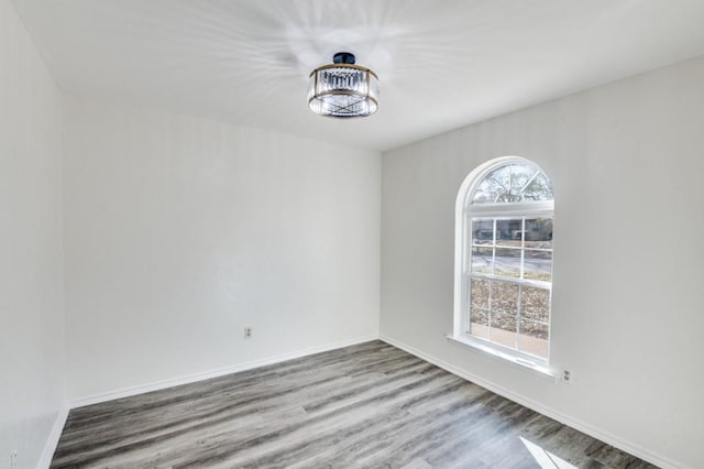 empty room featuring baseboards and wood finished floors