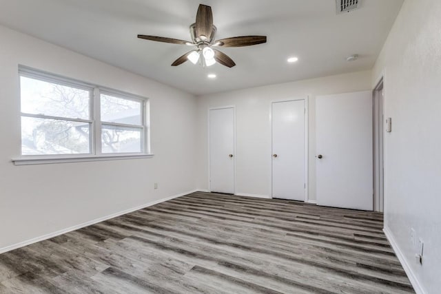 unfurnished bedroom with ceiling fan, recessed lighting, wood finished floors, visible vents, and baseboards