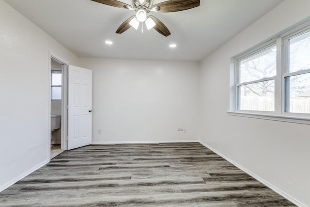 empty room with a ceiling fan, recessed lighting, baseboards, and wood finished floors