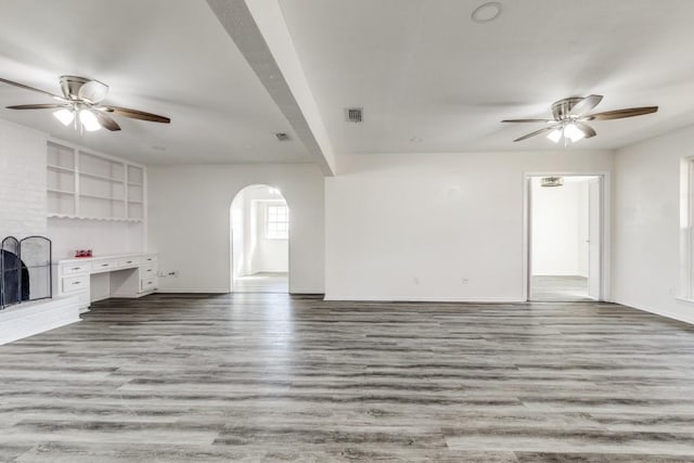 unfurnished living room featuring a ceiling fan, light wood-type flooring, and visible vents